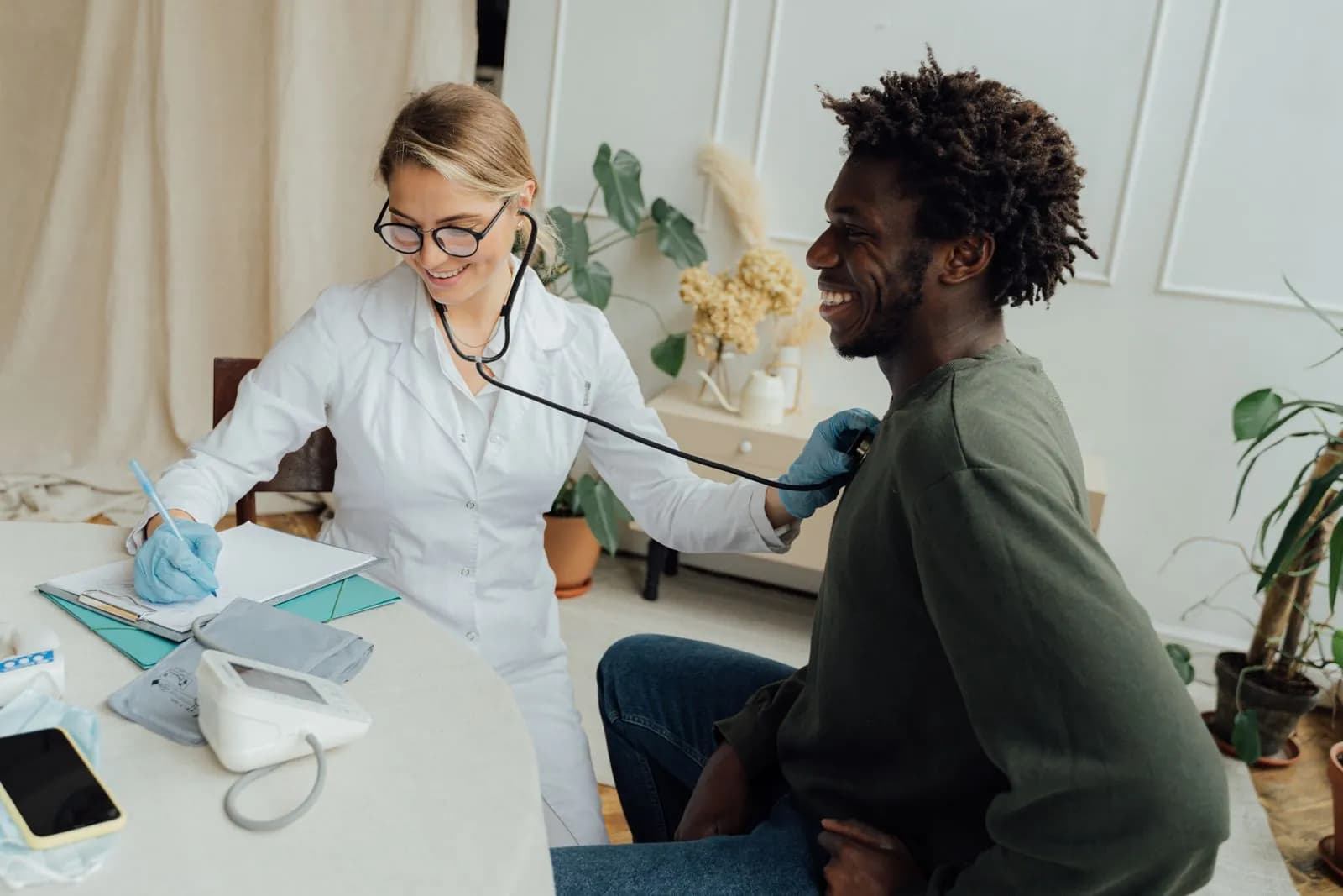 A GP listening to a patient's chest during a consultation